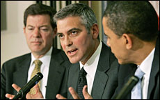 George Clooney in the company of two senators. <font size=-2>(Source: NZ Herald)</font>