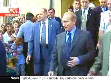 Russian President Vladimir Putin comes out to meet the enthusiastic crowds after his party's victory <font face=Arial size=-2>(Source: CNN)</font>