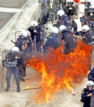 Athens rioting: A Molotov cocktail explodes among a group of riot police <font face=Arial size=-2>(Source: Independent)</font>