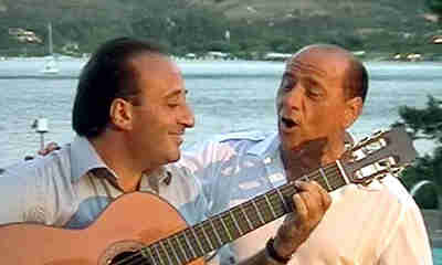 Italian prime minister Silvio Berlusconi (right) performs with Italian composer Mariano Apicella at a private function in 2003 in Sardinia (AFP)