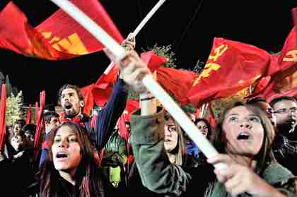 Hot communist chicks shout slogans in front of the Greek parliament building in Athens.  (AFP)