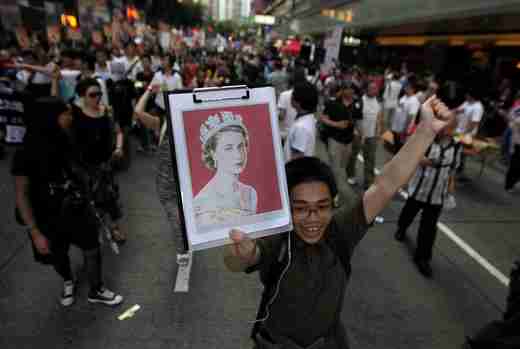 Young Hong Kong protester carries a picture of Queen Elizabeth on Sunday (Reuters)