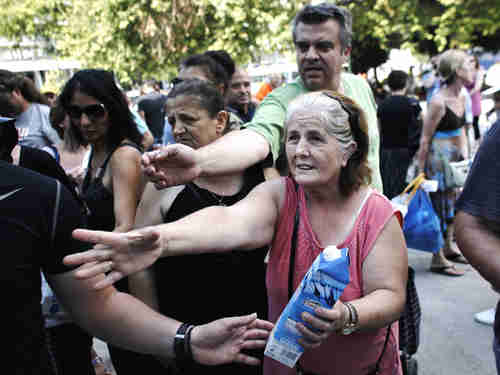 Golden Dawn supporters receiving handouts (AFP)