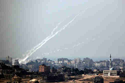 Trails of smoke are seen after the launch of rockets from the northern Gaza strip towards Israel on Wednesday (Reuters)