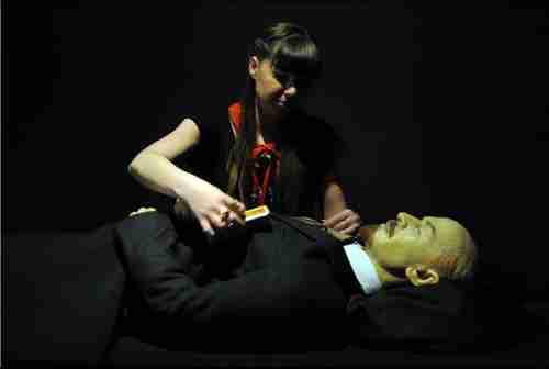 An employee adjusts the embalmed body of Nicolai Lenin (Vladimir Ilyich Ulyanov) (AFP)