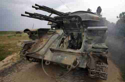 A Syrian army soldier sits inside a tank (AFP)