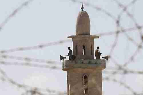 Egyptian soldiers stand guard on top of a minaret in Sinai (AFP)