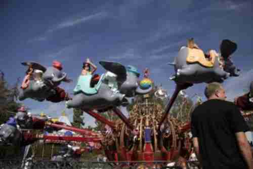 Visitors ride Dumbo the Flying Elephant at Disneyland in Anaheim on Thursday (AP)