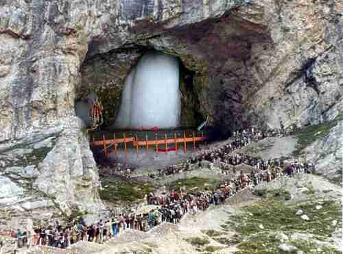 Long lines of pilgrims visiting the Amarnath shrine in 2016.  Inside the 40 m (130 ft) high cave, water drops from melting snow fall from the roof of the cave to the floor, creating a stalagmite that grows upward.