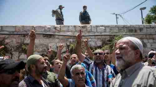 Muslim worshippers chant slogans outside the al-Aqsa mosque (Times of Israel)