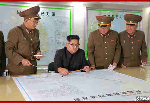 Kim Jong-un inspects the army's proposed plans for launching missiles towards Guam on Monday (KCNA)