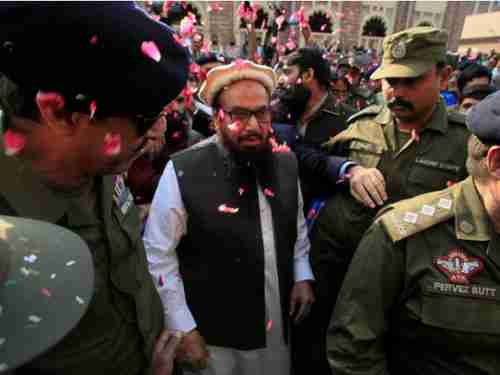 Hafiz Saeed, mastermind of the horrific 2008 26/11 Mumbai massacre, is released from jail and receives cheers and showers of rose petals (Reuters)