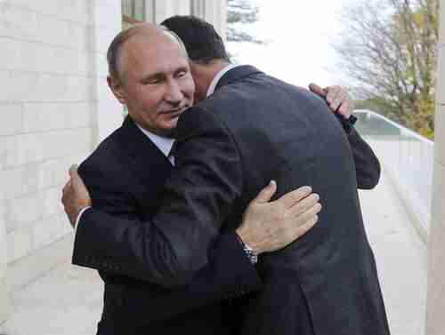 Vladimir Putin and Bashar al-Assad hug and say that the Syria war is at an end (AP)