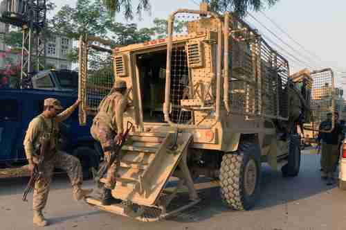 Pakistan army soldiers board an army vehicle in Peshawar on June 24, 2017 (AFP)