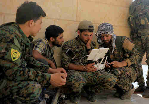 US soldiers train Kurdish SDF forces in how to control a drone (Reuters)
