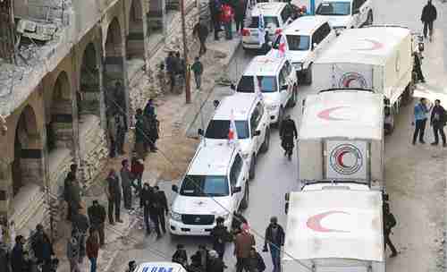 Trucks from humanitarian convoy in Eastern Ghouta on Monday (Reuters)