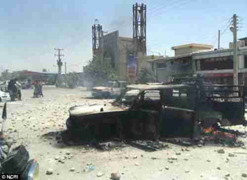 A picture of Kazerun on Friday shared on social media shows upturned and burnt out cars and wounded activists following violent scenes (NCRI)
