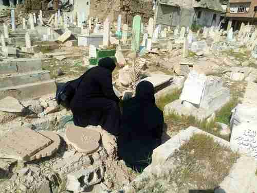 Two women bid farewell to their deceased families on March 24, before fleeing Ghouta for Idlib province (Syria Deeply)