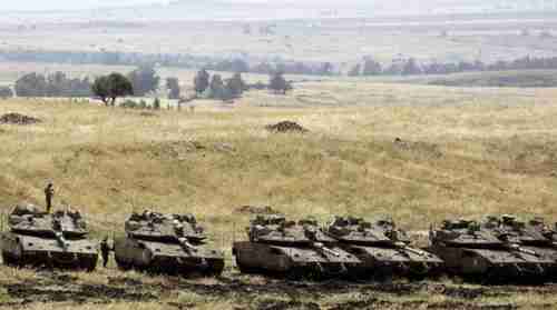 Israeli Merkava Mark IV tanks take positions near the Syrian border in the Golan Heights on May 10, 2018. (AFP)