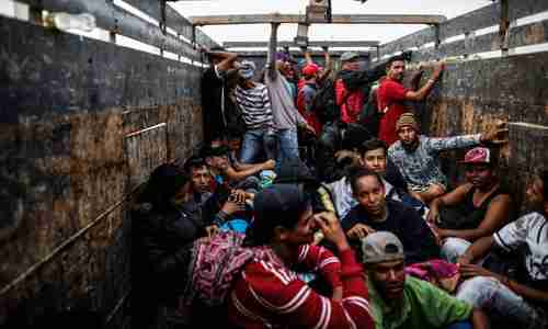 Venezuelan migrants travel aboard a truck in Tumbes, Peru, near the Ecuador border, on November 1. (AFP)