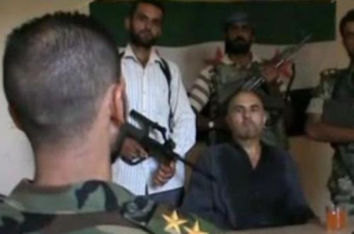 Syrian rebels with captured pilot -- still image from video (al-Jazeera)