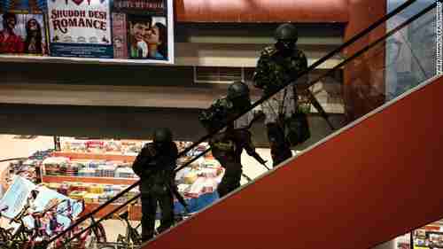 Soldiers move up stairs inside Westgate Mall in Nairobi Kenya on Saturday (CNN)