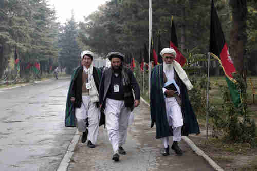 Loya Jirga delegates walk on the streets of Kabul, Afghanistan, on Friday (AP)