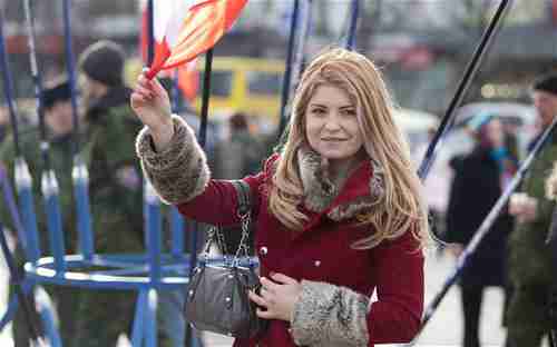 Girl celebrates referendum victory on Sunday in Lenin Square in Simferopol, the capital city of Crimea (Telegraph)