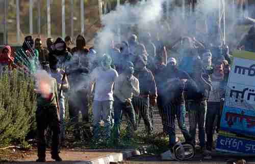 Israeli-Arab protesters clash with police in northern Israel on Sunday (AP)