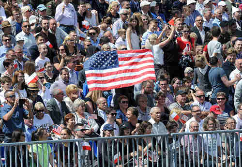 A large American flag-waving crowd greets Donald Trump in Warsaw Poland on Thursday