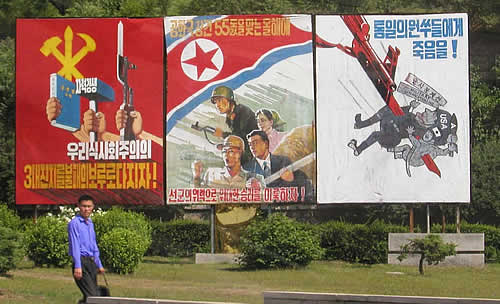 Prominent billboard in Pyongyang, North Korea, 2003.  The right-most frame shows a North Korean spearing an American with a bayonet.