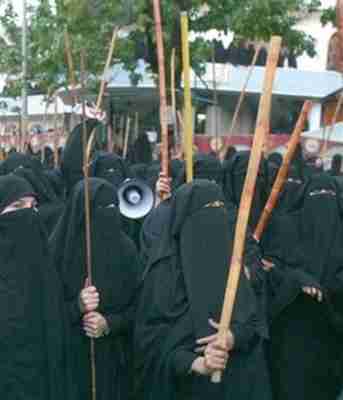 Protesting female students at Red Mosque seminary wearing burkas and carrying bamboo sticks in 2007