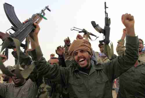 Pro-Gaddafi forces celebrating victory in Ajdabiyah on Wednesday (Reuters)