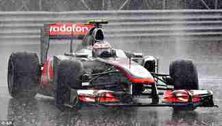 Jenson Button wins the Canadian Grand Prix on Sunday in an upset in the pouring rain (AP)