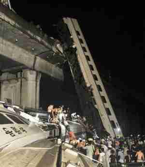 Wreckage of train after two carriages fell off a bridge (AP)