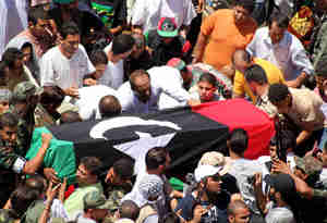 The body of Abdel Fatah Younes is carried through the streets of Benghazi on Friday (Getty)