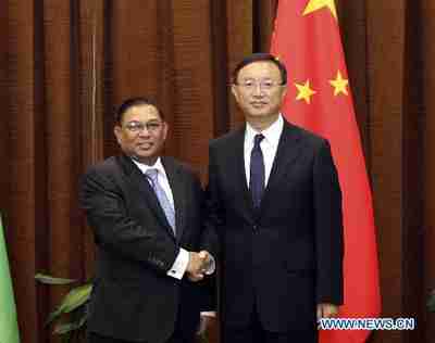 Burma's foreign minister (left) shakes hands with his Chinese counterpart in a visit to Beijing on Tuesday (Xinhua)