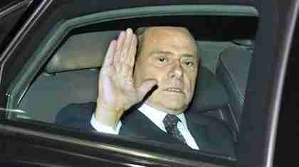 Berlusconi glumly waving last November, after being forced out of office (AP)