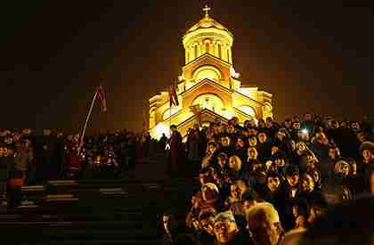 Georgians attend Orthodox Christmas celebrations at the Holy Trinity Cathedral in Tbilisi, early Saturday (AP)