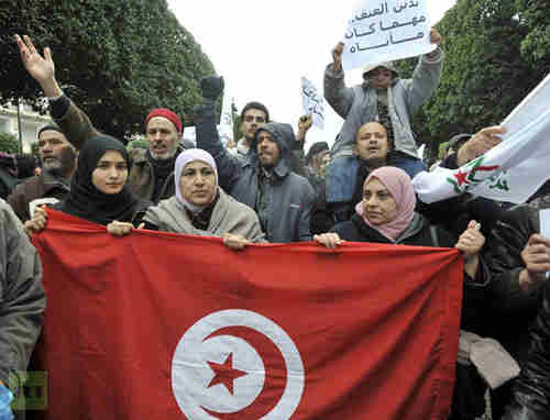 Ennahda supporters hold up Tunisian flag on Saturday (AFP)