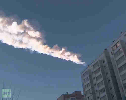 The trail of a meteorite is seen above a residential apartment block (Reuters)