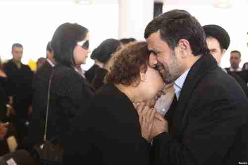 Ahmadinejad hugs Chávez's mother, Elena Frias, during funeral services on Friday (Reuters)
