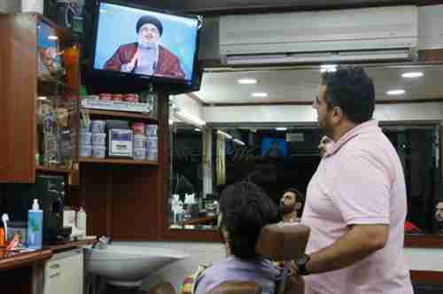 People watch Nasrallah on television on Tuesday (Daily Star)