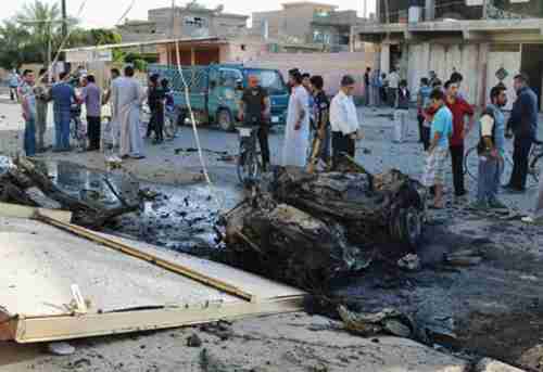 Scene of two parked car bombs north of Baghdad on Sunday (AP)