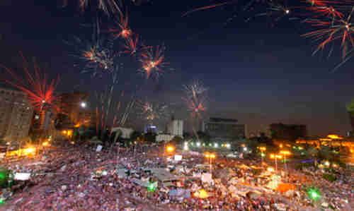 Fireworks burst over anti-Morsi protesters in Cairo's Tahrir Square (AP)