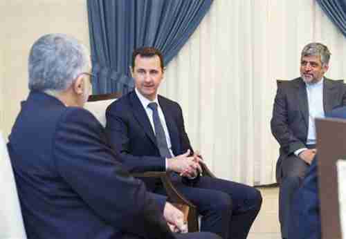 Bashar al-Assad smiles on Monday at a meeting where he's presumably celebrating the number of Sunni women and children civilians he's torturing and killing (Reuters)