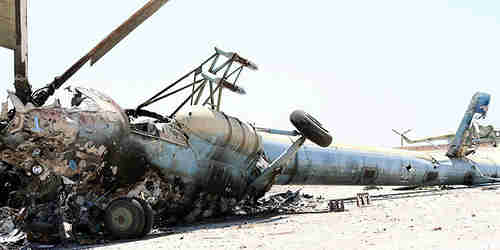  A destroyed Russian-made helicopter that belonged to the Syrian army is seen at the Minnigh military airport (Reuters)