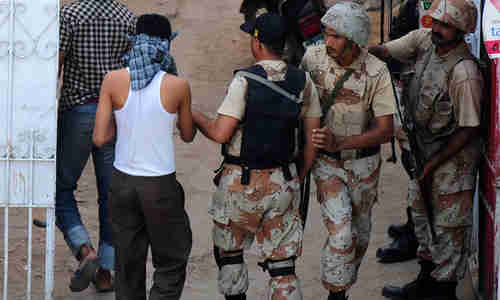 Paramilitary soldiers arrest suspects in a residential area in Karachi (AFP)