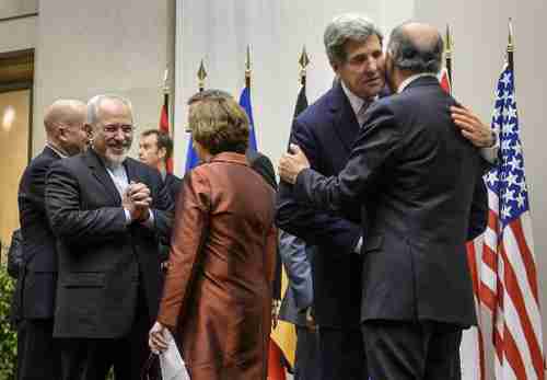 Foreign ministers from (L-R) Iran, EU, U.S. and France laugh and hug after reaching agreement in Geneva on Sunday (AFP)