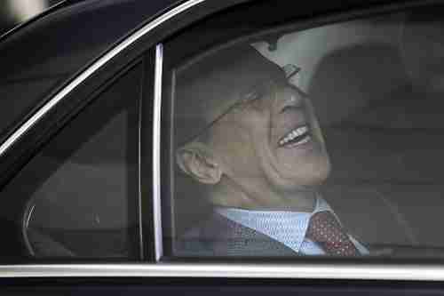 Russia's foreign minister Sergei Lavrov laughs hysterically as his car pulls away from the conference venue (AFP)
